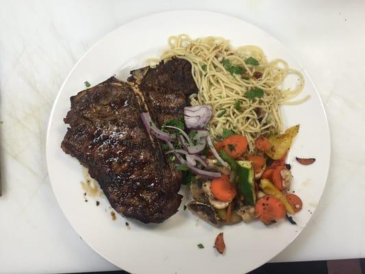 T-Bone steak with pasta and grilled vegetables