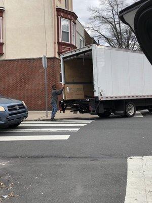 Ebenezer moving a heavy box