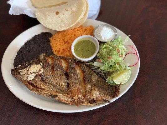 whole tilapia fried with rice, bean,salad and hand make tortillas