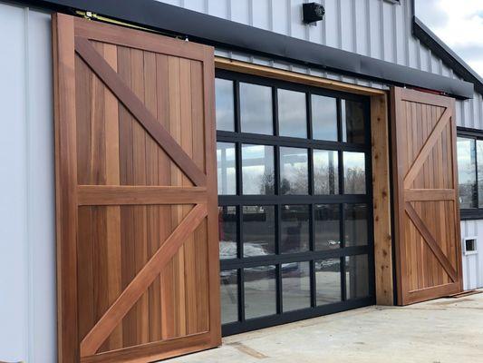 Full view glass door with cedar slider on a pool house