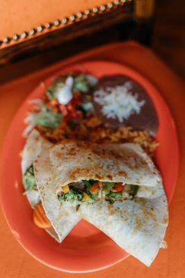 Vegetarian quesadilla served with rice, beans, and salad.