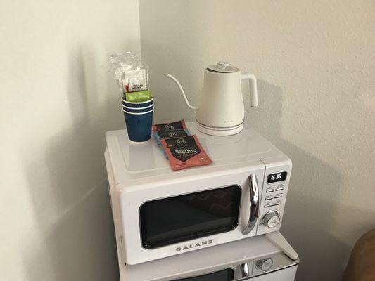 Microwave oven, water kettle and coffee above the retro refrigerator