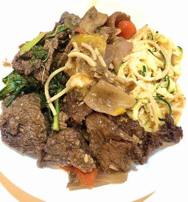 Beef stir fry over garlic noodles