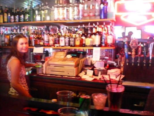 Melissa trying to look sober behind the bar