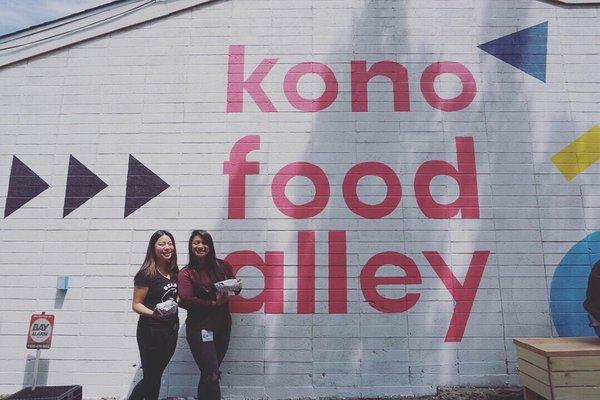 Posing with the Kono Food Alley mural art.