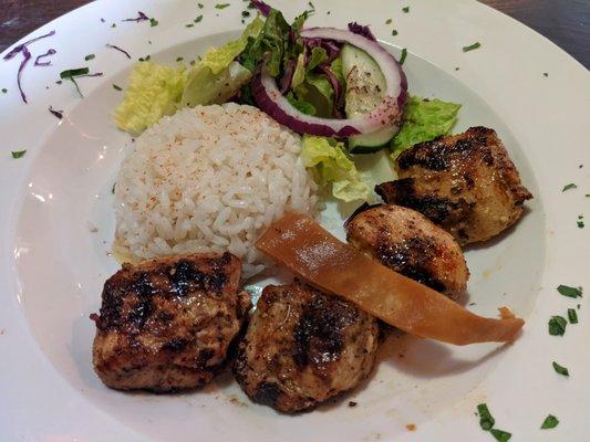 Grilled shish tawuk with rice and salad.