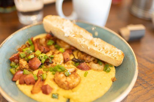 Shrimp and Grits. With tomatoes onions and sausage.