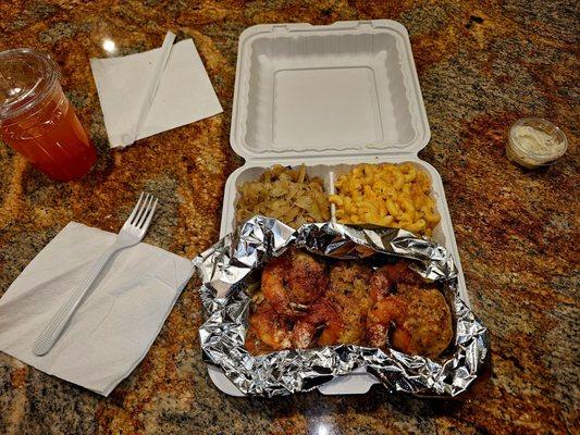 Colossal stuffed shrimp with sides of cabbage and Mac and cheese.