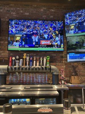 At the bar with tvs and plenty of choices of tap.