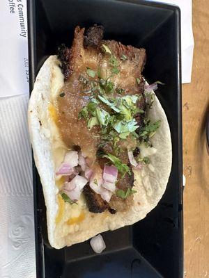 Whiskey Row taco, $6, pork belly, bourbon glaze, cheese, red onion, cilantro