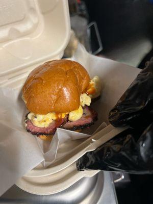 Smoked beef brisket slider: brioche bun, sliced brisket, mac n cheese, Takeover BBQ sauce