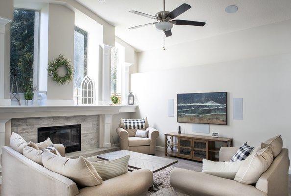 Professionally mounted TV, in-ceiling speakers, in-wall speakers in living room.