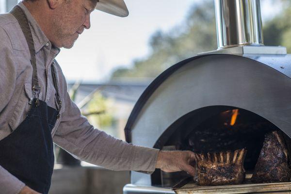 Imported from Italy, Chef using our Rossofuoco Single Chamber Wood-Fired Pizza Oven.