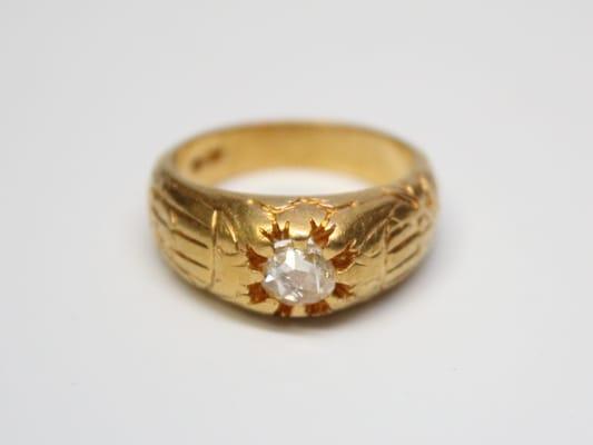 An Art Nouveau era gents ring with an antique rose cut diamond and lustrous depletion gilded finish.