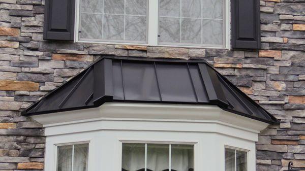 A nice new metal roof installed to the delight of this happy customer, by Pinnacle Exteriors