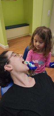 Patient brushing moms teeth.