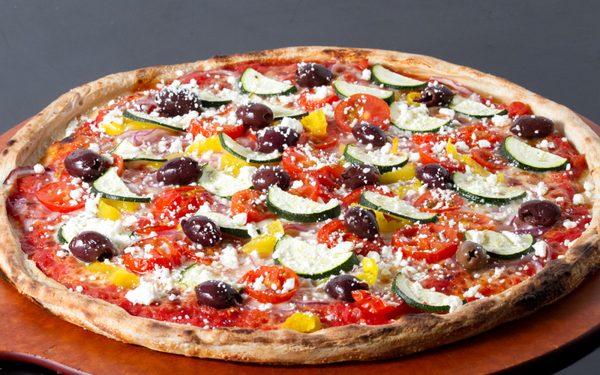 Greek Pizza: Italian tomato sauce, mozzarella, roasted zucchini, fresh red onion, fresh cherry tomatoes, pepperocini, kalamata olives & feta