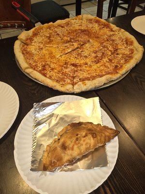 Cheese pizza pie and chicken empanada