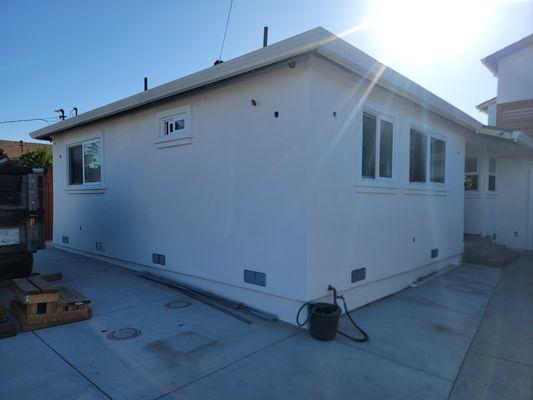 New stucco installed after repairing damaged wood.