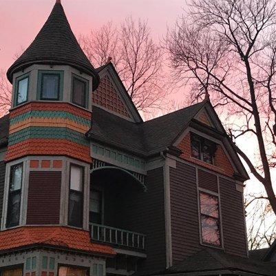 Colorful house with a rosy sunset behind