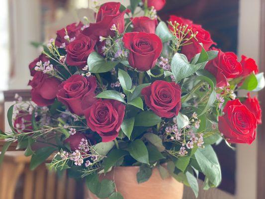 Lavender filler flowers complement the perfect red roses. Generous, artistic arrangements!