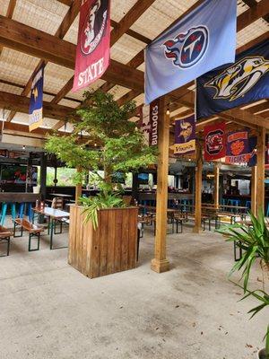 Outdoor bar area with TVs for sporting events