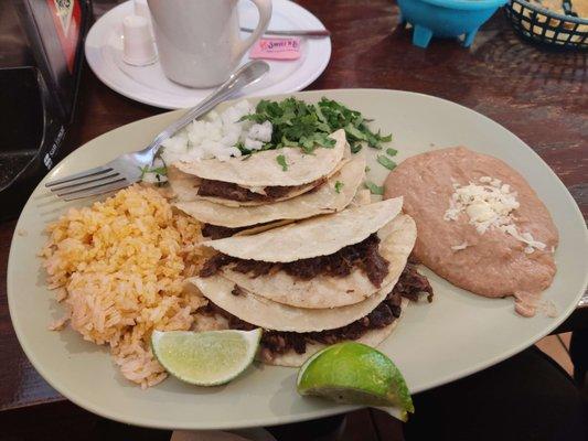 barbacoa tacos - arrived with lime, onion, cilantro, rice, and refried beans