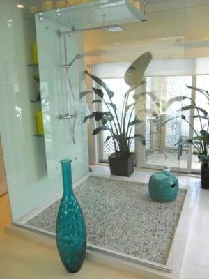 Custom-designed shower with pebble floor and open glass creates a great space.