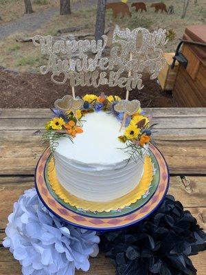 Vanilla cake and lemon curd filling with buttercream frosting and fresh flower decorations!