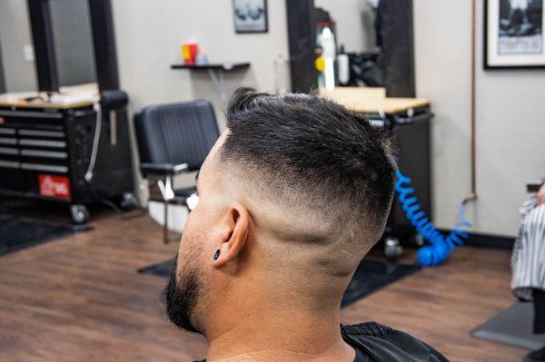 Skin fade with a small trim on top