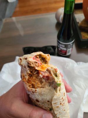 First bite of heaven of the Sam burrito with carne asada.