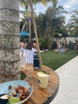 Tables on the trees and corn hole game