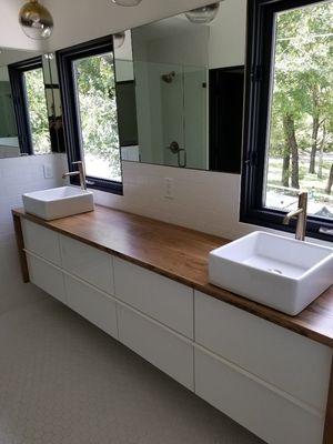 2 vessel sinks and faucets we installed on a floating cabinet.