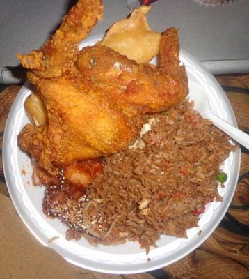 a plate of joy luck food...chicken wings, crab stick, sesame chicken, house fried rice, under there is fried fish