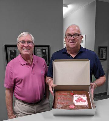 Steve Waddell's office birthday celebration with a State Farm chocolate cake presented by Steve Borklund.