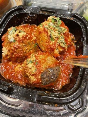 The meatball that is two different. I scraped of the sauce and the dark half was rock hard and dry the other half I  was able to cut .