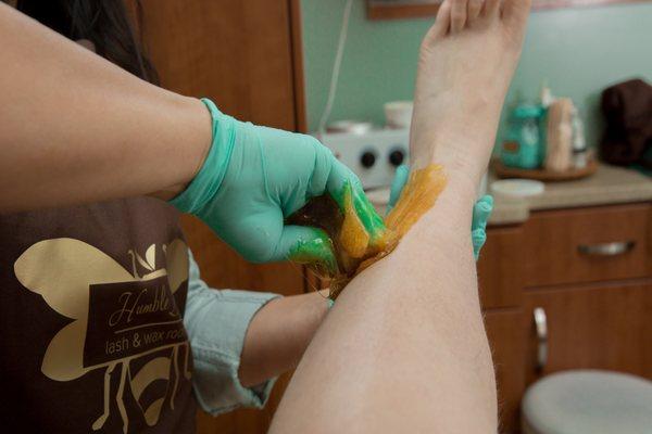 Body Sugaring uses a gloved hand to apply the sugar paste and a flicking motion of the hand to remove it.