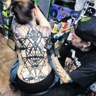 We offer custom professional work, call us with your ideas.
: Humo working on a back piece soon to be a full  custom geometric body suit