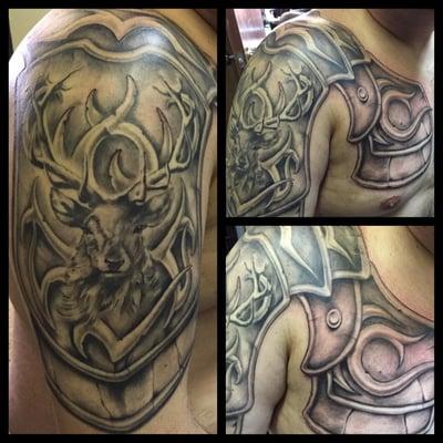 Shoulder and Chest Armor Tattoo with a stag and tribal design.