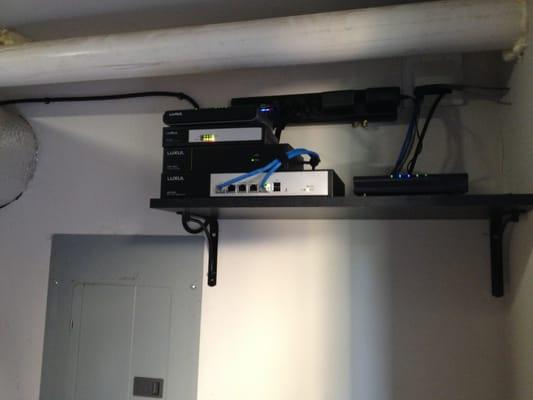 Home mesh network system hidden in utility room. This system provides seamless wifi coverage in a 4 story house.