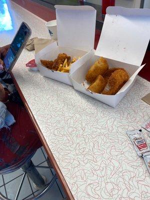 Chicken strips fries and onion rings