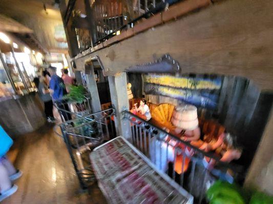 A (fuzzy) view of the lower-level seating/dining area with a view of the counter in the background.