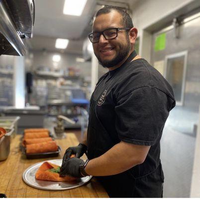 Chef Benny rolling up his famous breakfast burritos!