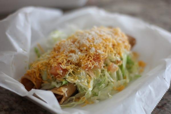 rolled tacos with creamy guacamole, lettuce, cheese, & tomato