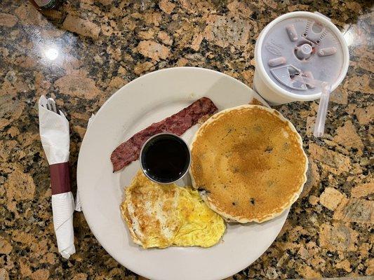 Kids 1-1-1 with Blueberry Pancakes, Turkey Bacon and 1 Egg Fried hard. Cranberry Juice to drink.