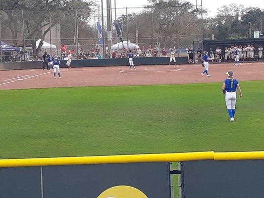 3rd base bleachers behind 8 ft. fence