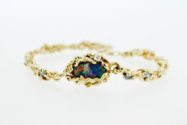 Custom Australian Opal bracelet in hand carved wax that was cast, finished and set in our studio.