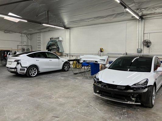 Pair of Teslas about to receive some body work.