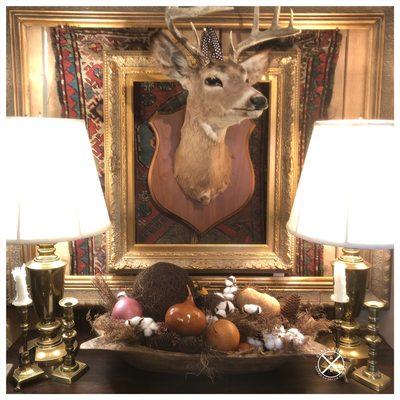 We love taxidermy, paired with blingy gold frames and vintage rugs!