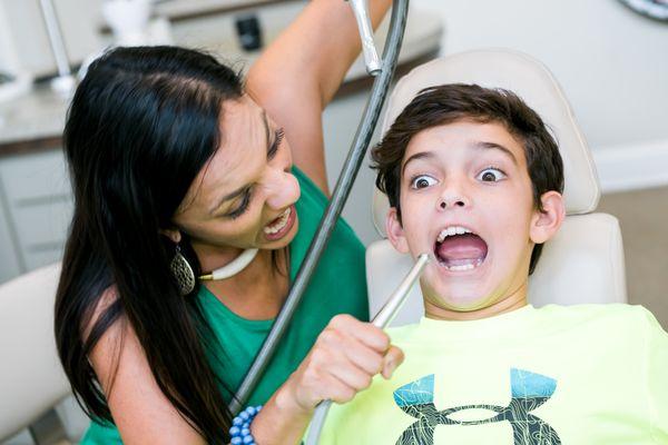 This mother is having  a little fun with her son.  Parents are welcome to come on back during their child's Orthodontic appointment.